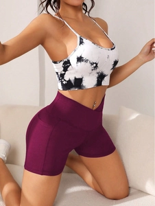 Close-up of cross high waist sports shorts with side pockets and tie-dye yoga tank top