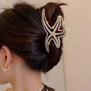 French elegant starfish hair claw clip with rhinestones and pearls on dark hair