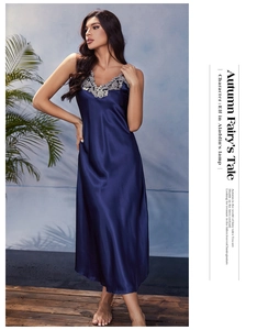 Detail of navy blue satin nightgown featuring elegant V-neckline with silver lace trim