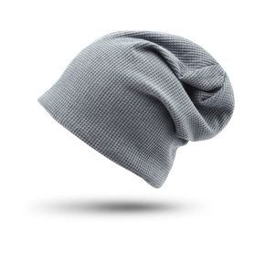 Detail view of gray slouchy beanie featuring a textured waffle knit pattern and cozy fabric