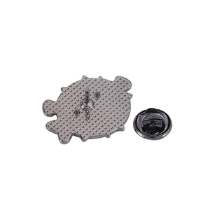Detail of the pin back featuring a black alloy non-slip texture and metal butterfly clasp