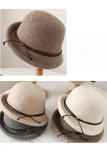 Detail of wool cloche hat with thin leather strap and heart-shaped metal buckle