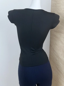 Detailed back view of black slim-fit athletic T-shirt with vertical center seam design