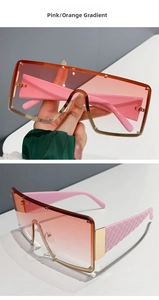 Detail of pink and orange gradient lens sunglasses with golden metal frame and textured temples