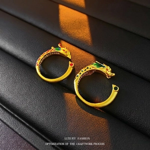 Golden dragon and phoenix open rings with colorful enamel details on black leather