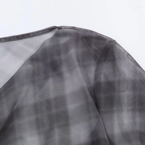 Detailed close-up of grey mesh fabric showing fine grid print and precision stitching