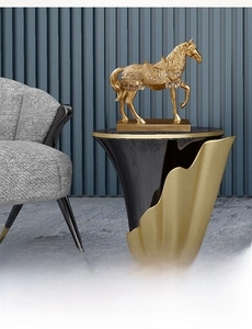 Detailed view of a golden resin horse statue with blue gemstone accents and stable base