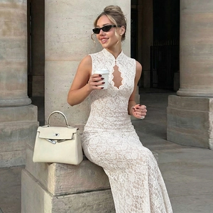 Dettaglio dell'abito in pizzo bianco senza maniche con ricami floreali e design con intaglio