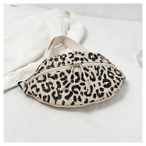 Detail of straw woven waist bag featuring beige and black leopard print with zipper