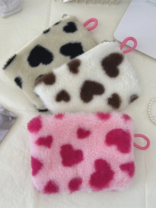 Three plush heart lipstick pouches in white, brown, and pink with elastic lanyards