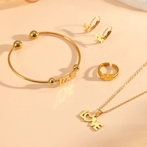 Elegant gold-plated LOVE jewelry set featuring necklace, bracelet, earrings and ring