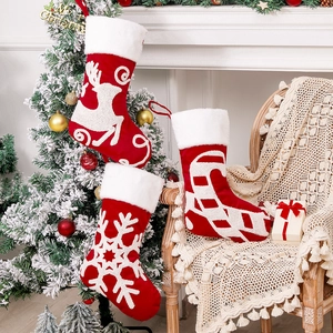 European Christmas stockings with embroidered reindeer and snowflake in festive home setting