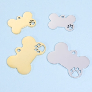 Mirror polished stainless steel bone pendants with hollow paw prints in gold and silver
