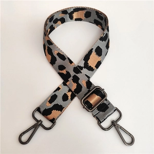 Detail of leopard print wide strap with gunmetal hardware and adjustable buckle for cross-body bags