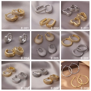 Detailed grid of earrings in gold and silver finishes with zircon stones and various shapes