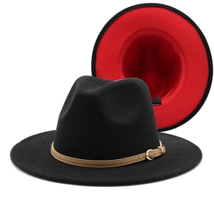 Close-up of wool fedora hat featuring black exterior, red lining and leather band buckle