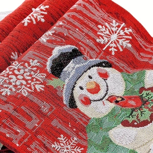 Close-up of festive Christmas table runner featuring woven snowman and snowflake patterns