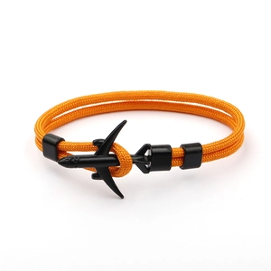Detail of orange paracord woven bracelet with a black airplane anchor fastener