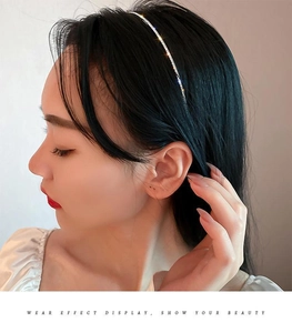 Detail of slim rhinestone bow headband on a model showing sparkling silver finish