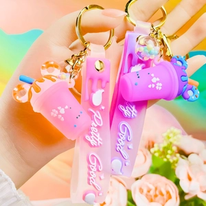 Close-up of pink and purple drink cup keychains with donut lids and pretty good straps