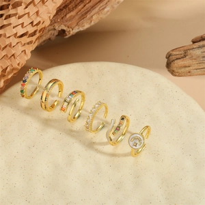 Set of six vintage gold adjustable rings with moon star designs and zircon on ceramic tray