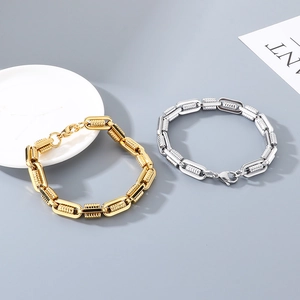 Detail shot of heavy metal geometric chain bracelets in gold and silver finish