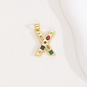 Detailed view of golden letter X pendant with colorful cubic zirconia and multi-shape gems