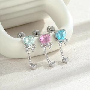 Three bow heart zircon stud earrings in mint green, pink, and light blue finishes