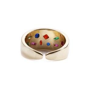 Detailed view of gold plated wide band ring with colorful embedded gemstones and polished finish