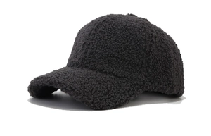 Macro detail of dark grey faux fur texture on a warm winter baseball cap
