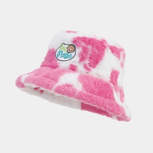 Close-up of pink cow pattern plush bucket hat with Sea Breeze shell embroidery patch