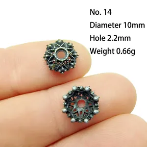 Macro shot of 10mm silver alloy flower bead spacer showing detailed hollow vintage craft