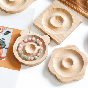Detailed view of handcrafted wooden jewelry trays with natural grain and bead displays