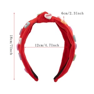 Detail of red plush Valentine's headband with colorful XOXO heart charms and sizing data