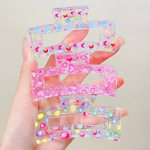 Three-piece transparent hair claw set with butterfly, heart, and polka dot floral prints