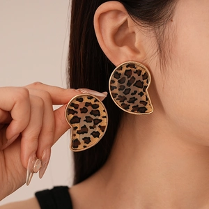 Close-up of stylish leopard print resin earrings with elegant gold metallic borders