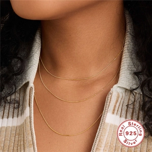 Three-layered 925 sterling silver gold plated necklaces worn by a female model