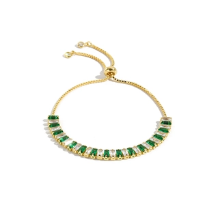 Adjustable gold bracelet with emerald green and white baguette-cut zirconia stones