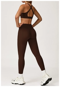 Detail of cross-back sports bra and high-waist leggings with side pocket in coffee brown