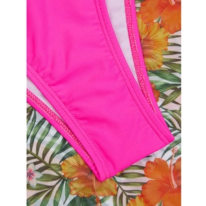 Detailed macro view of hot pink bikini fabric featuring durable double-stitch sewing seams