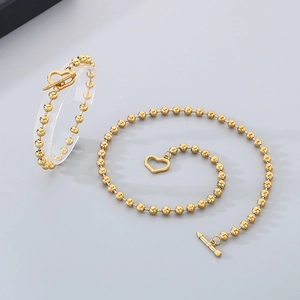 Golden beaded necklace and bracelet set with heart pendant and OT toggle clasp