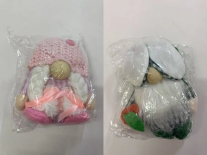 Detailed view of pink and green Easter faceless gnomes with bunny ears in packaging