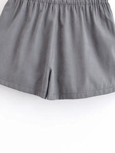 Close-up of dark grey cargo skort featuring elastic waistband and detailed stitching