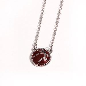 Detailed close-up of a red basketball pendant with silver metal chain on white background