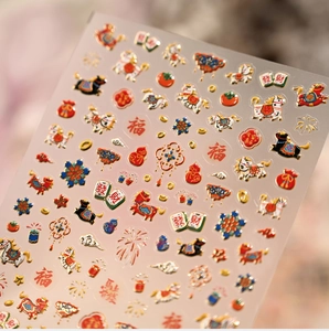 Macro detail of 3D embossed nail stickers with Chinese New Year motifs and gold foil