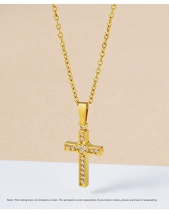 Detail of gold cross pendant with crystal heart and micro zircons, chain not included