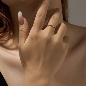 Minimalist gold heart ring shown on hand with high-quality polished finish and fine band