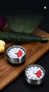 Macro detail of a magnetic kitchen timer with red visual countdown on a wooden board