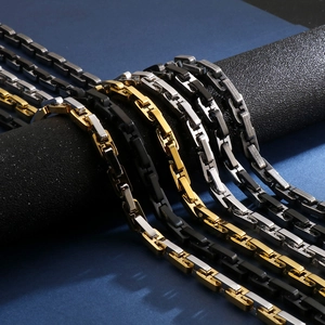 Close-up of geometric punk stainless steel link chains in gold, silver, and black finishes