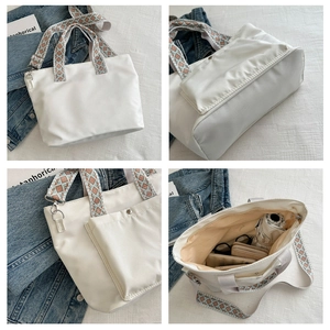 Detail of white tote bag with beige and blue geometric patterned wide shoulder strap